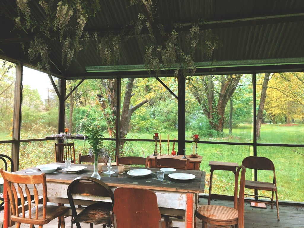 an outdoor dining area with a table and chairs