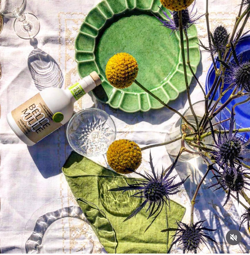 a table with flowers and a bottle of wine