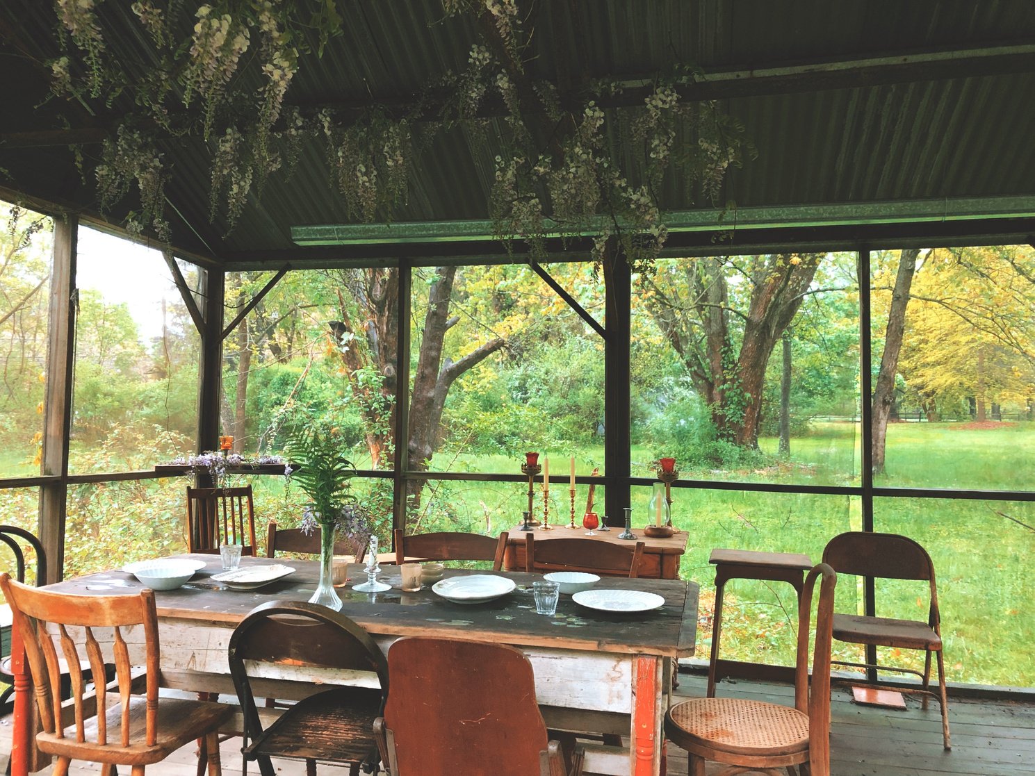 an outdoor dining area with a table and chairs