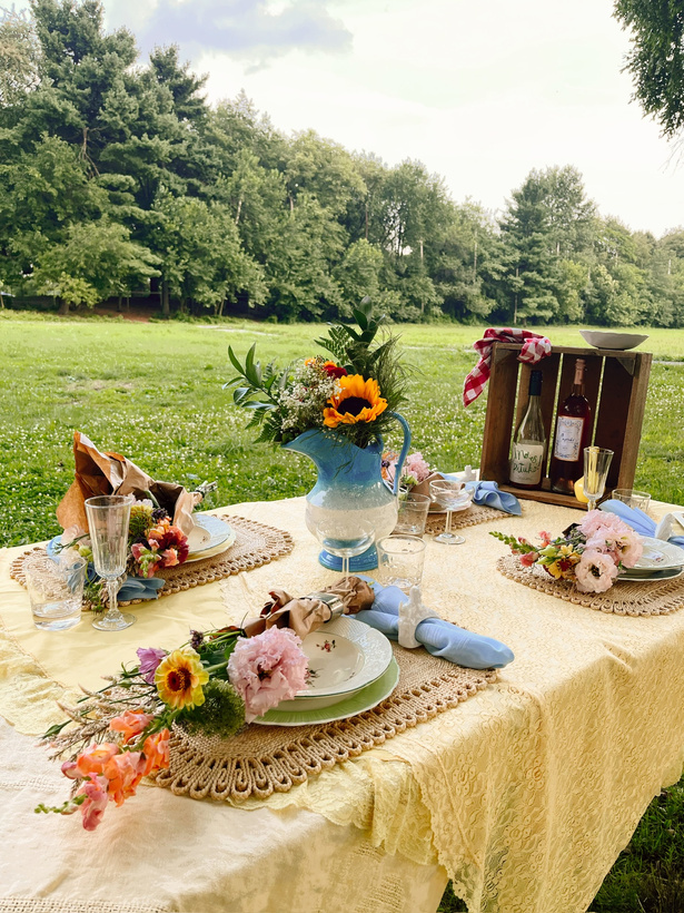 a picnic table set up in the middle of a grassy field