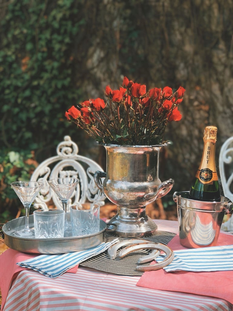 an outdoor table with a red and white striped tablecloth