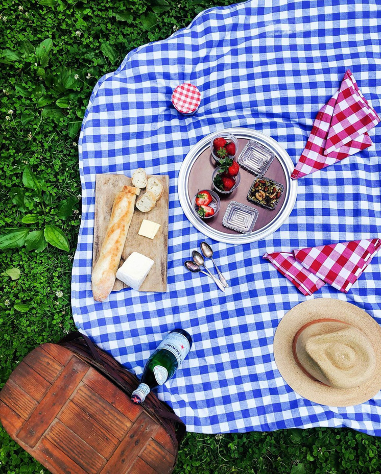 a picnic blanket with food and drinks on it